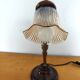 Gold swan neck table lamp with amber tulip glass.