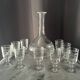 Service of an engraved art deco liqueur - captain's decanter and 9 matching glasses.