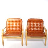 Upholstered leather armchairs 70s
