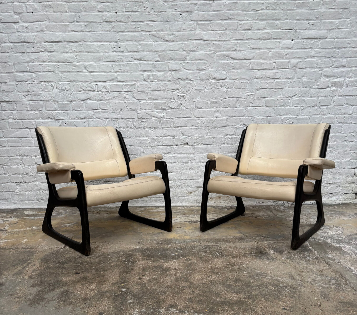 Set of two Baumann sled lounge chairs.