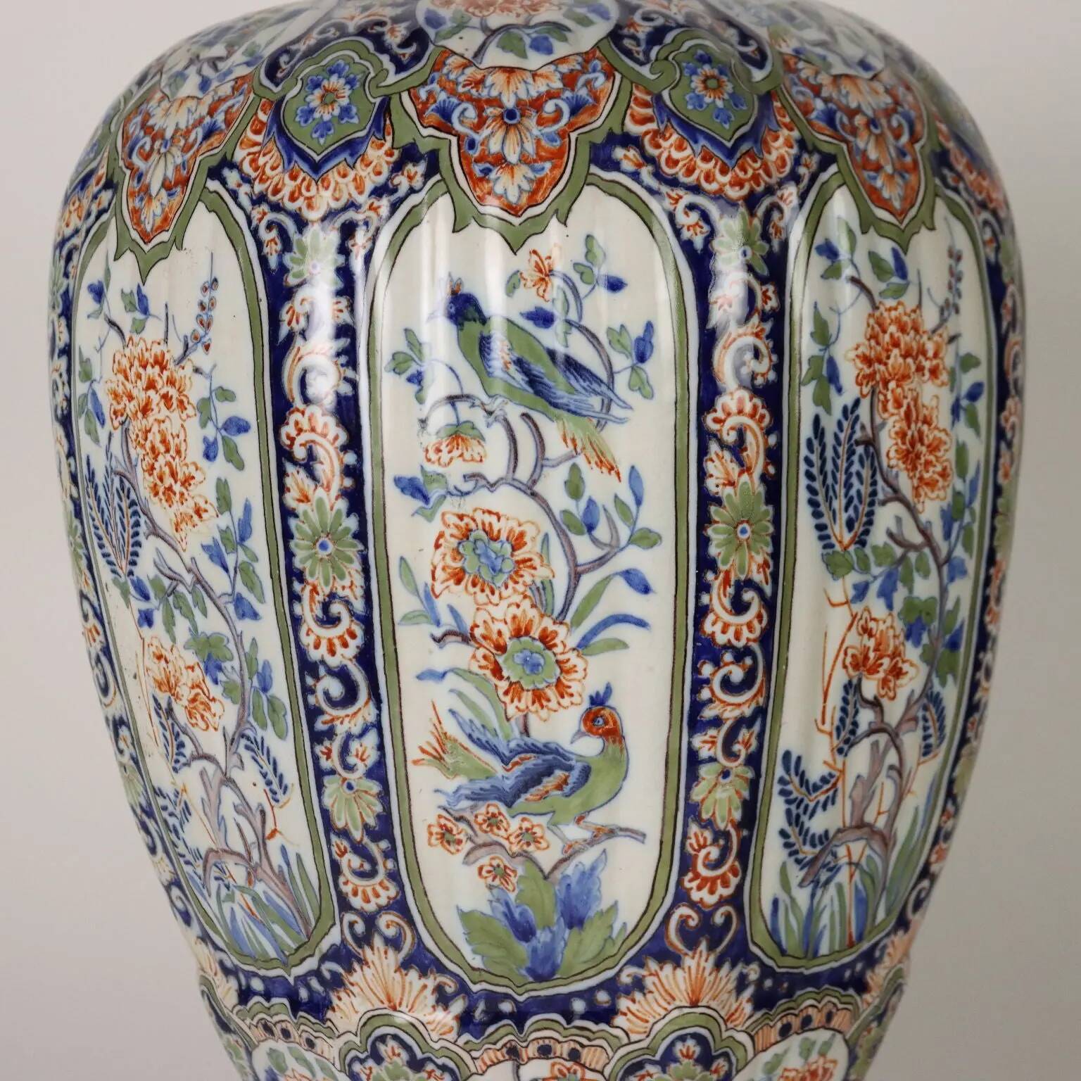 Ancient vase fully decorated with ceramic plants, 20th century.