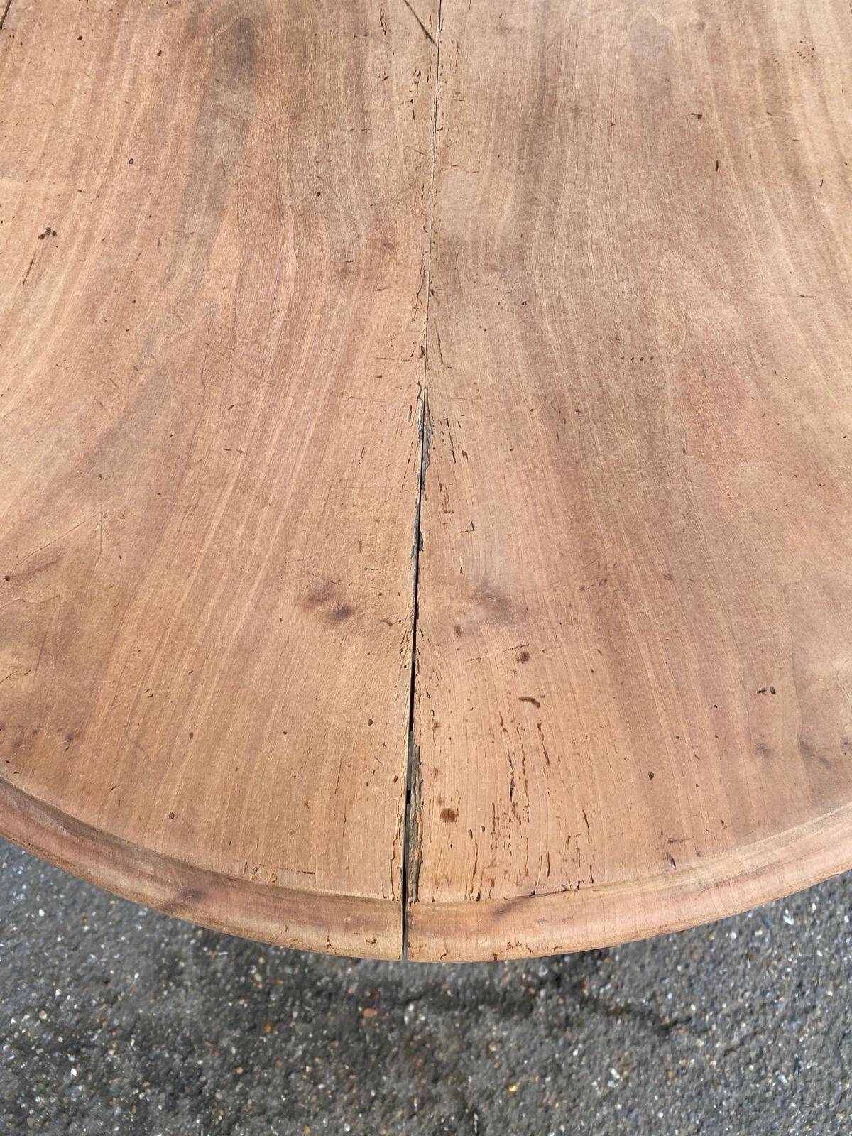 Renovated round extendable dining table with leaves made of solid wood.