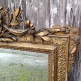 Wooden fireplace mirror and Gilded Louis XVI-style plaster with leaf