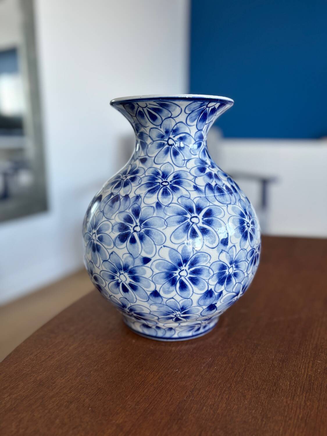 Blue and white ceramic vase with floral pattern in the shape of a vintage ball