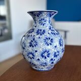 Blue and white ceramic vase with floral pattern in the shape of a vintage ball
