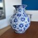Blue and white ceramic vase with floral pattern in the shape of a vintage ball