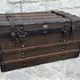 Old wooden and leather trunk, old brass nail trunk and leather strap