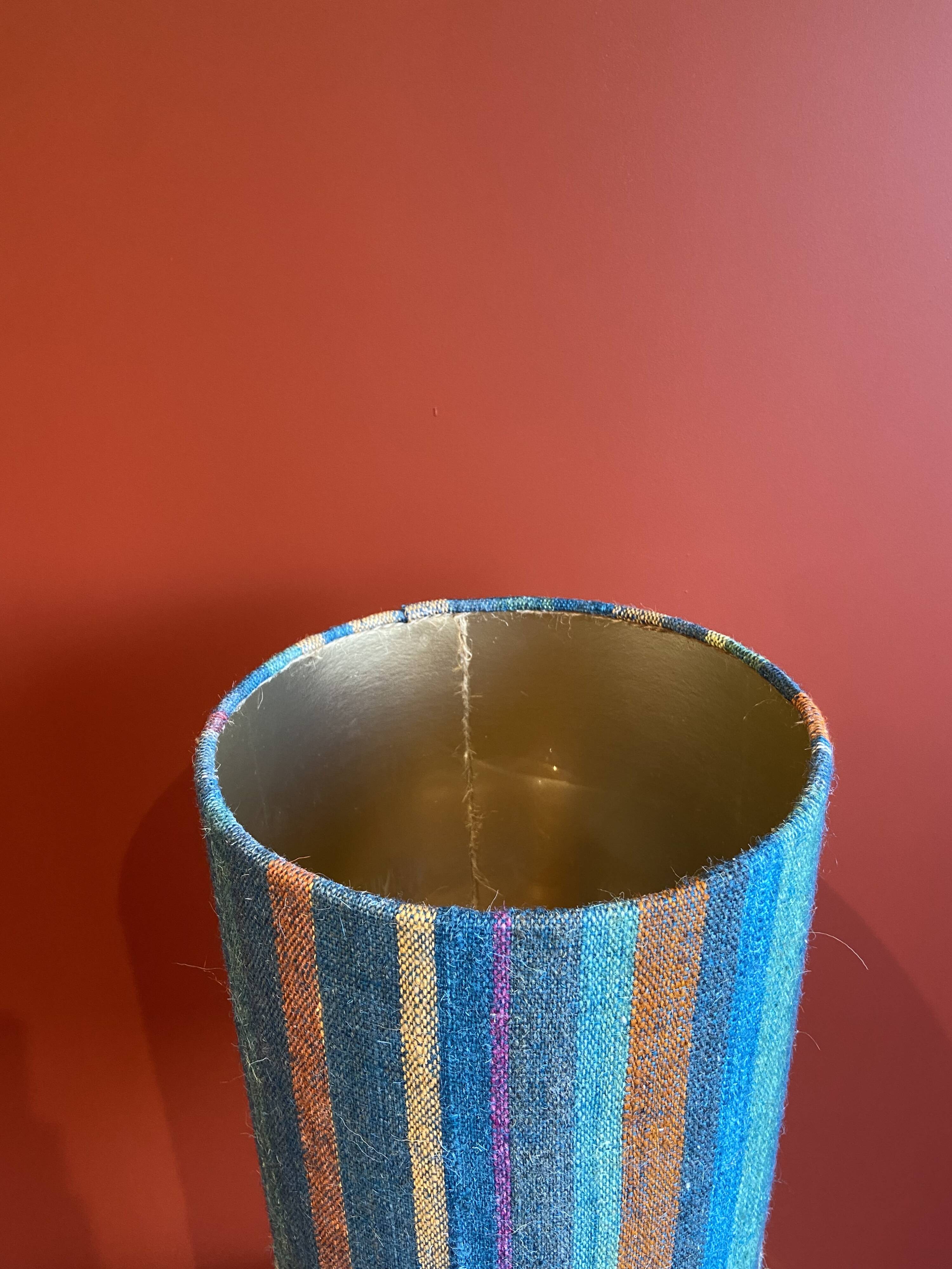 "Stoneware Bottle Lamp" with a multicoloured blue lampshade handwoven in India.