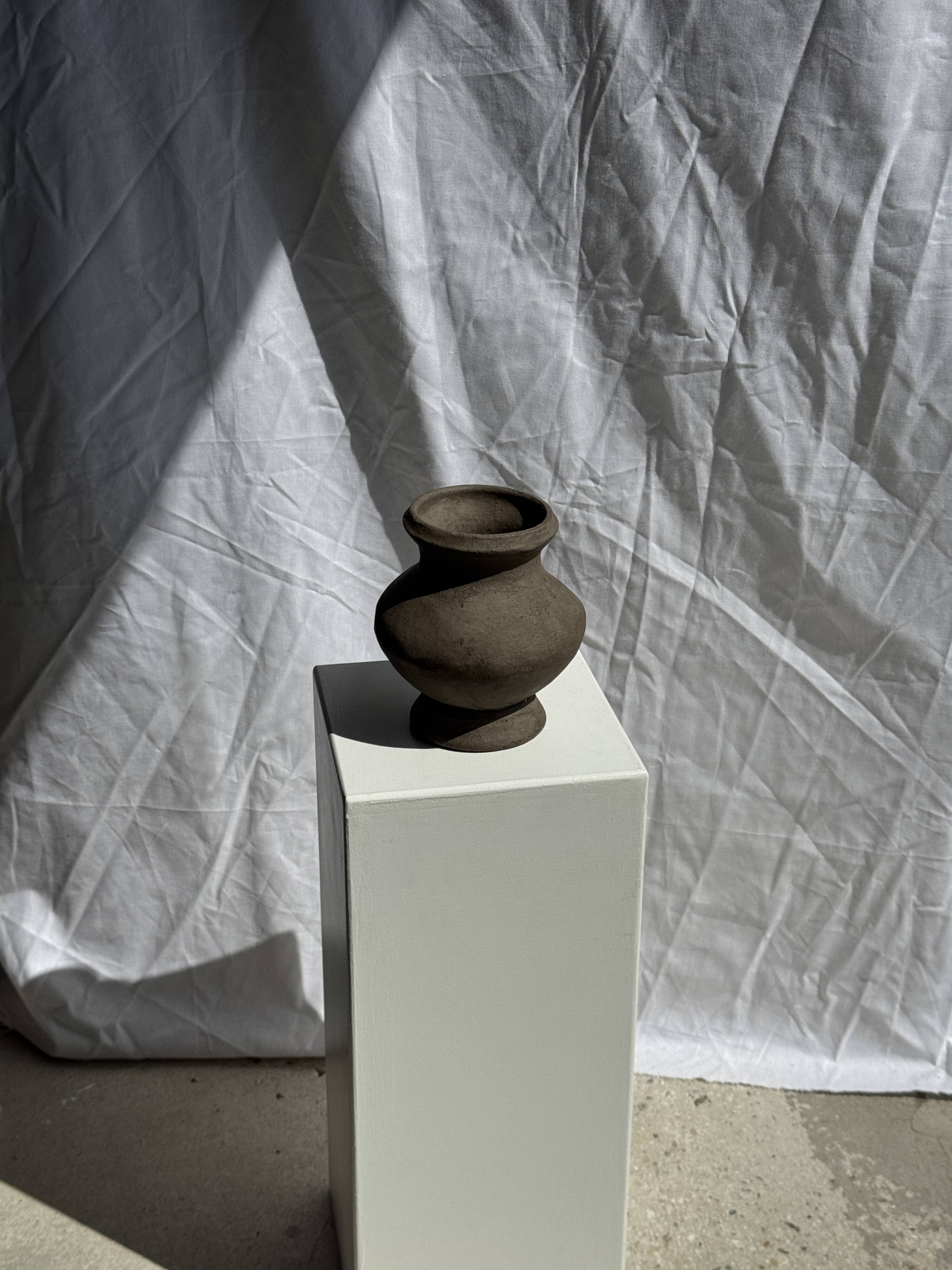 Small brutalist handcrafted terracotta vase with a pedestal, Indonesian, H19 D17.