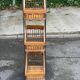 Woven rattan and steel display shelf in the shape of a staircase.