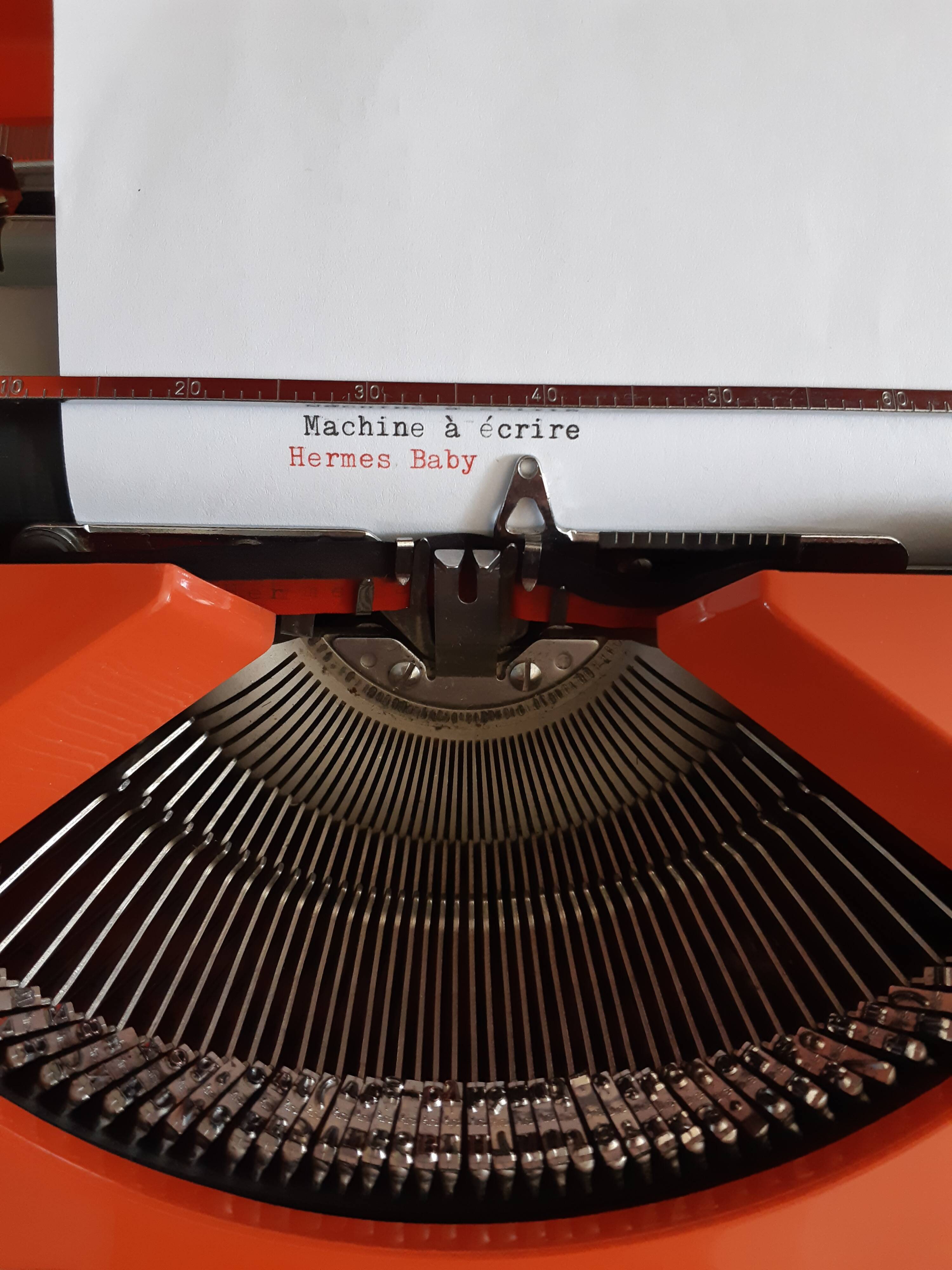 Hermes Baby orange typewriter, portable, functional