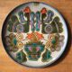 Vintage ceramic plate with peacock bird decoration.