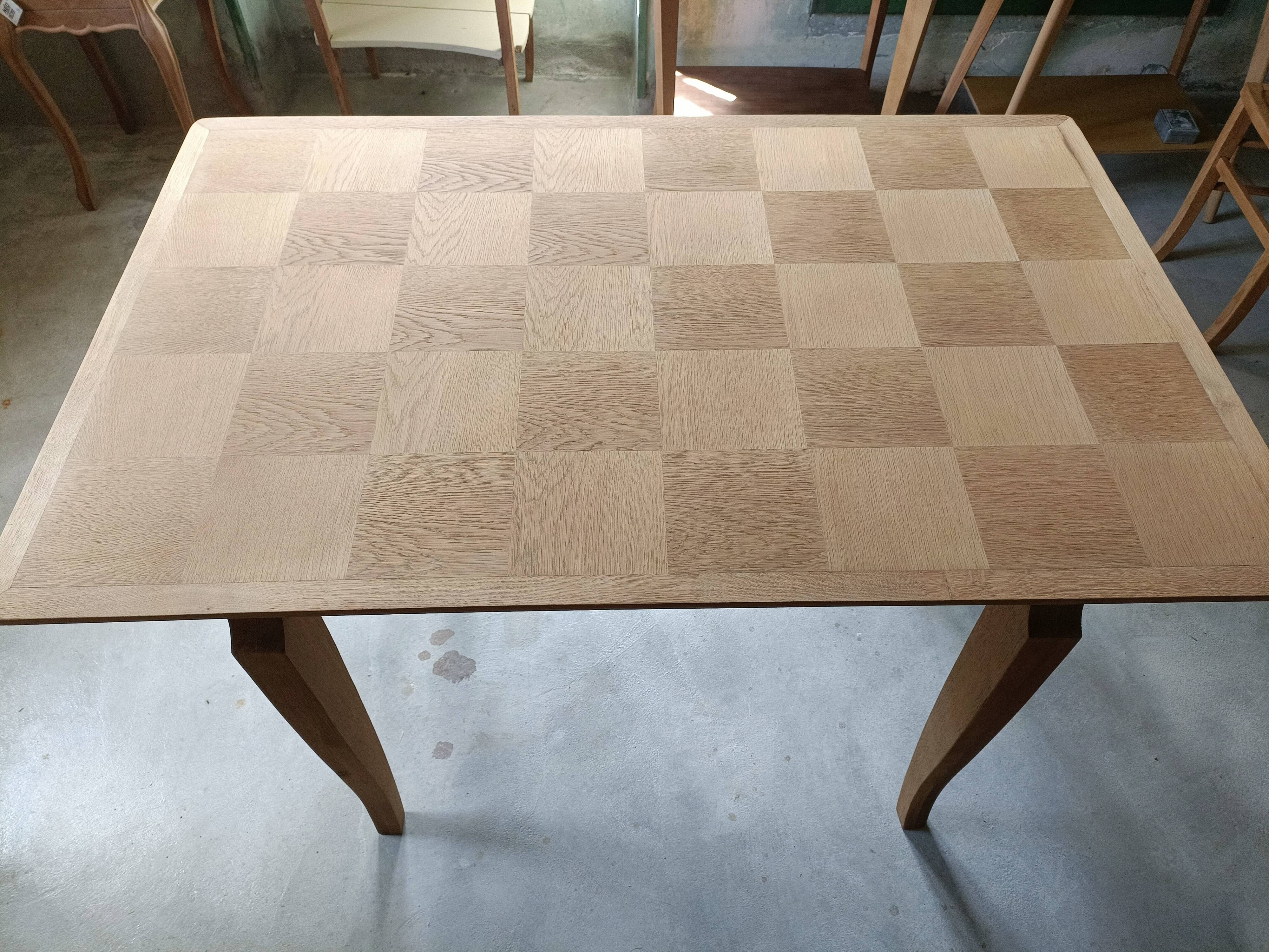 Oak dining table with a checkerboard top and extensions.