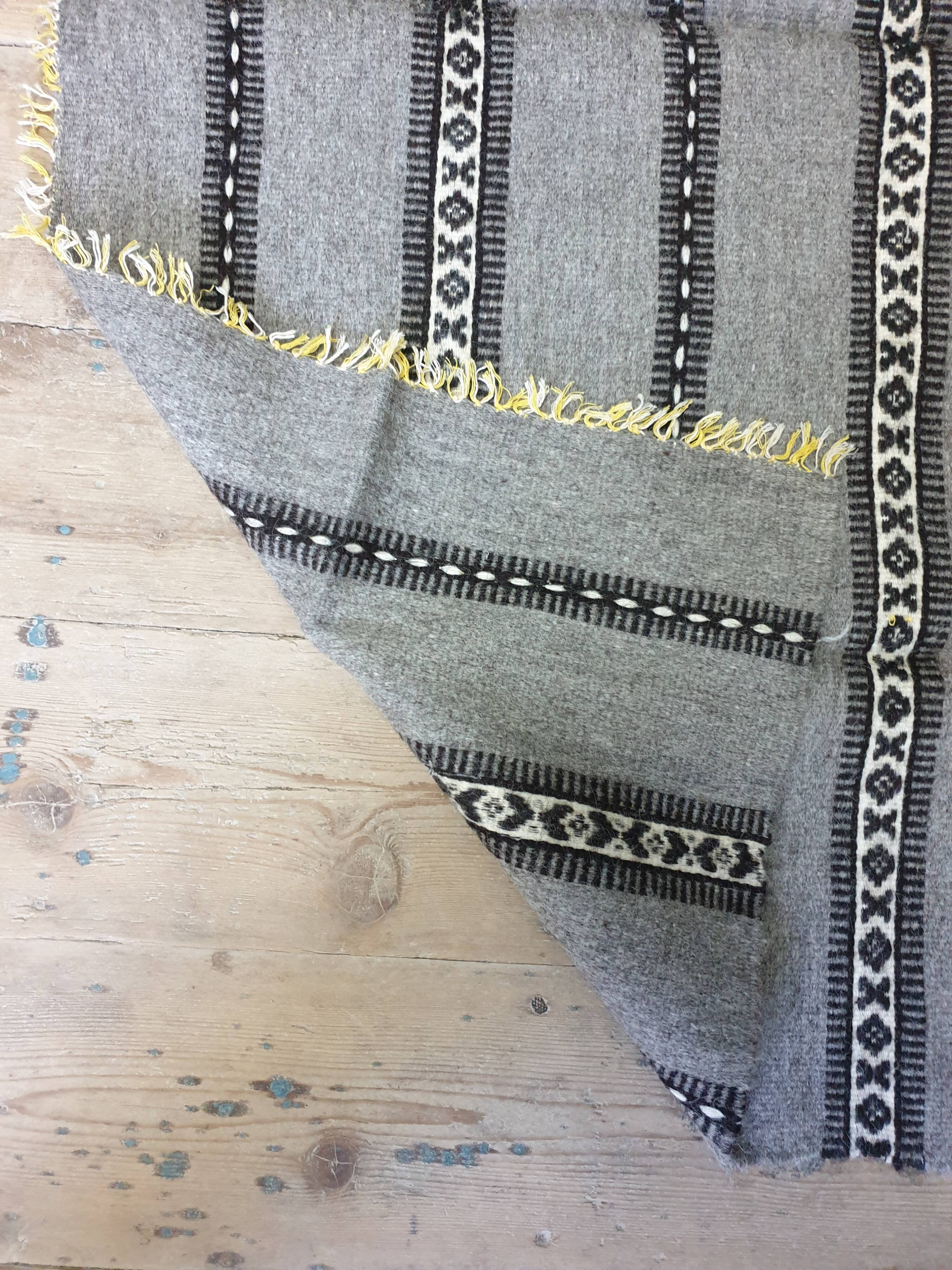 Handwoven vintage geometrical rug, grey background