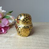 Old small black and gold lacquered wooden box in the shape of an owl