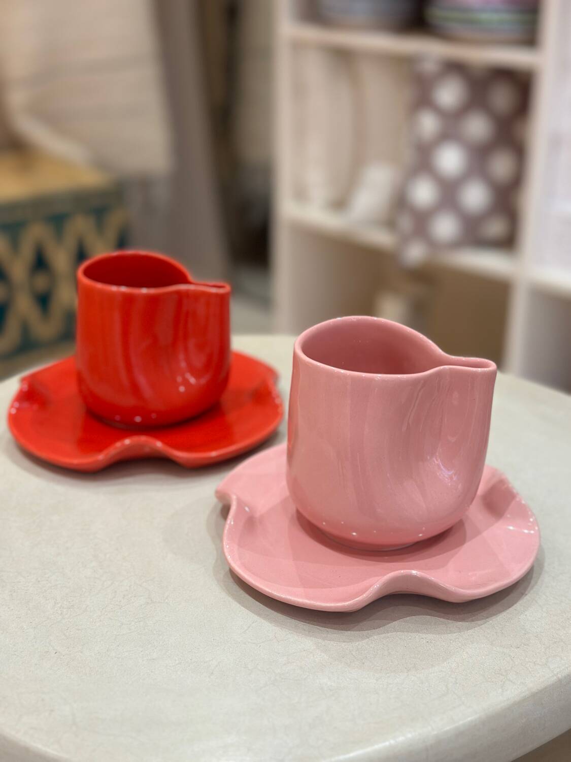 Set of ceramic artisan mugs with poppy red water lily design.