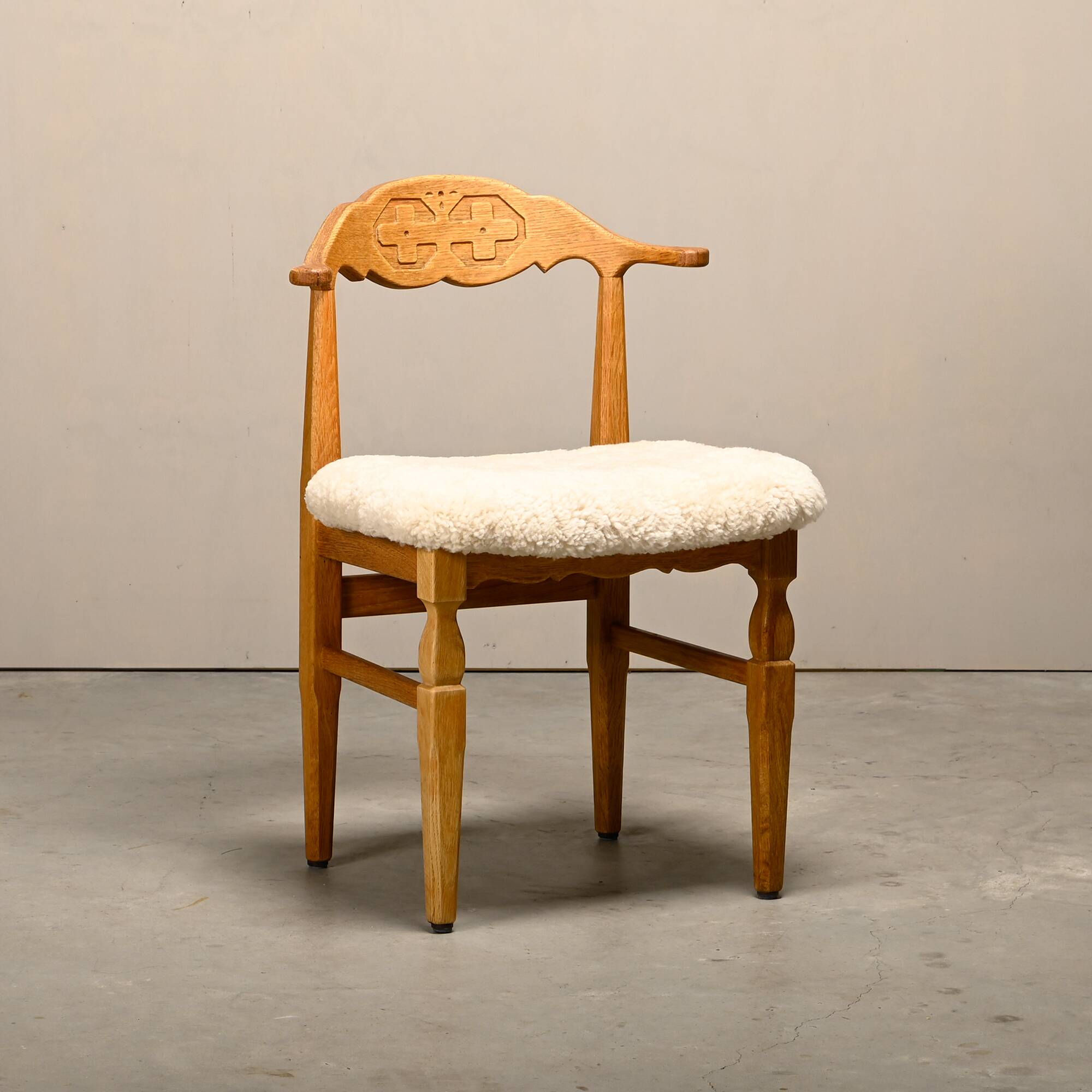 Henning Kjærnulf dining chairs set in Oak and Sheepskin, Denmark, 1960s
