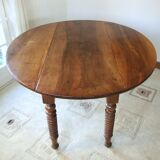 Mid-19th-century walnut round table with shutters, flaps