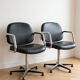 Pair of vintage swivel armchairs in metal and black faux leather.