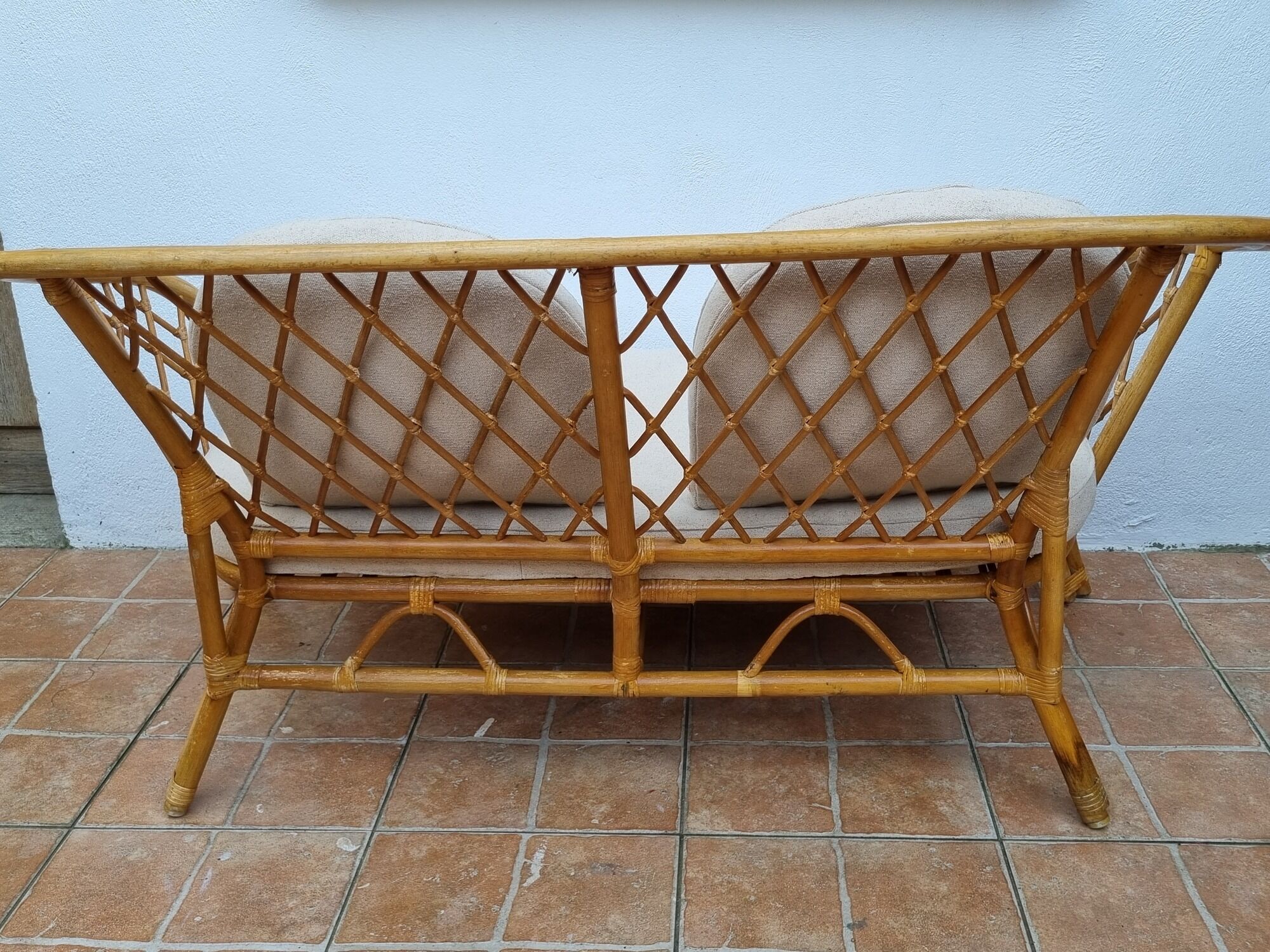 Vintage two-seater natural rattan sofa with cotton cushions, 140 cm