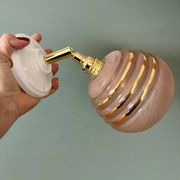 Vintage globe wall light in frosted pink and gold glass.