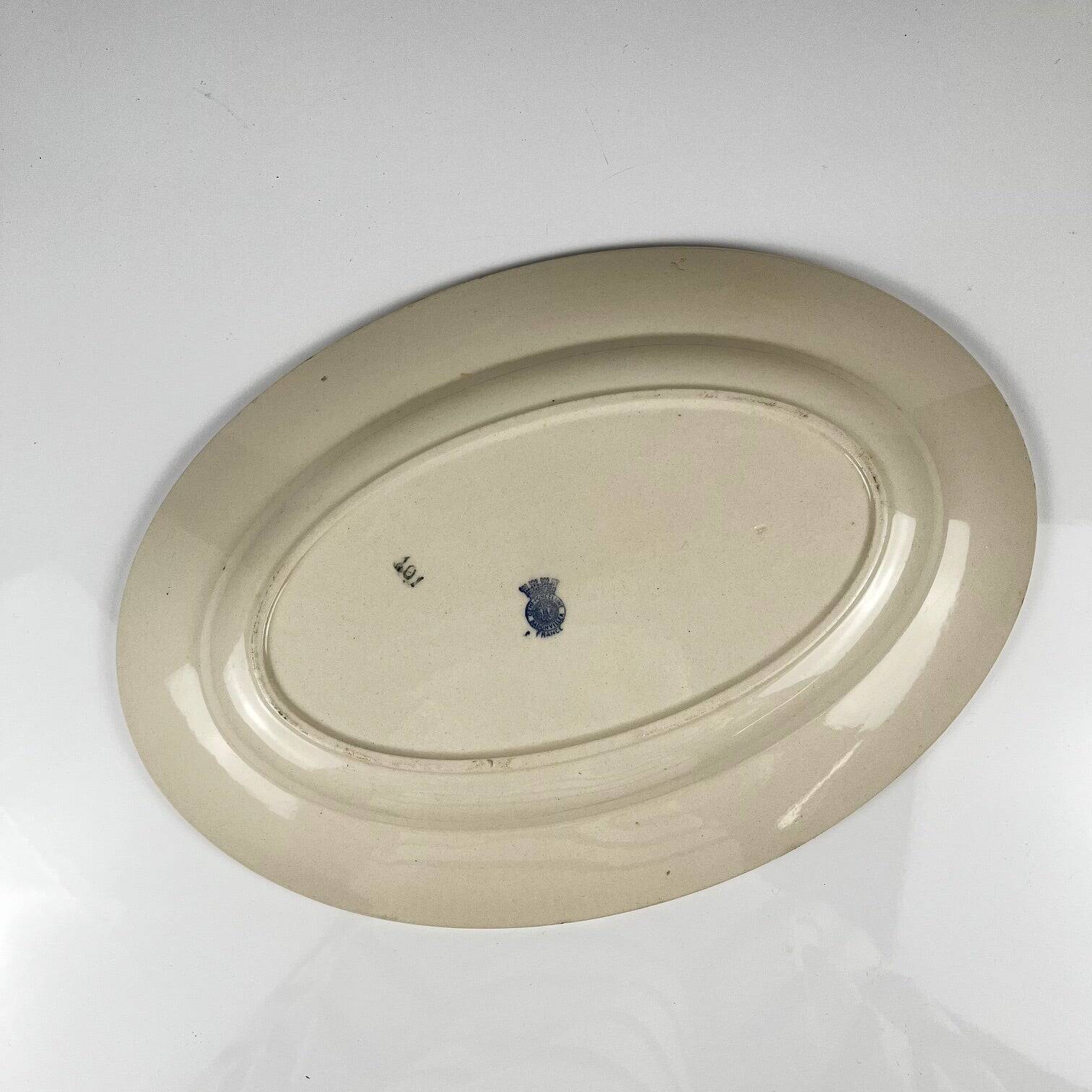 Oval half-porcelain plate from Badonviller, blue flower pattern, early 20th century.