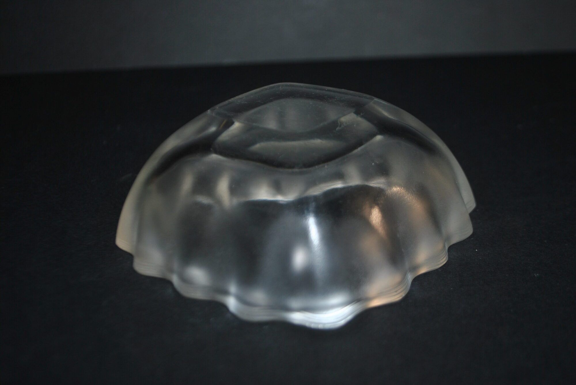 Lalique glass ashtray bowl with frosted finish, engraved with wave design, signed Lalique.