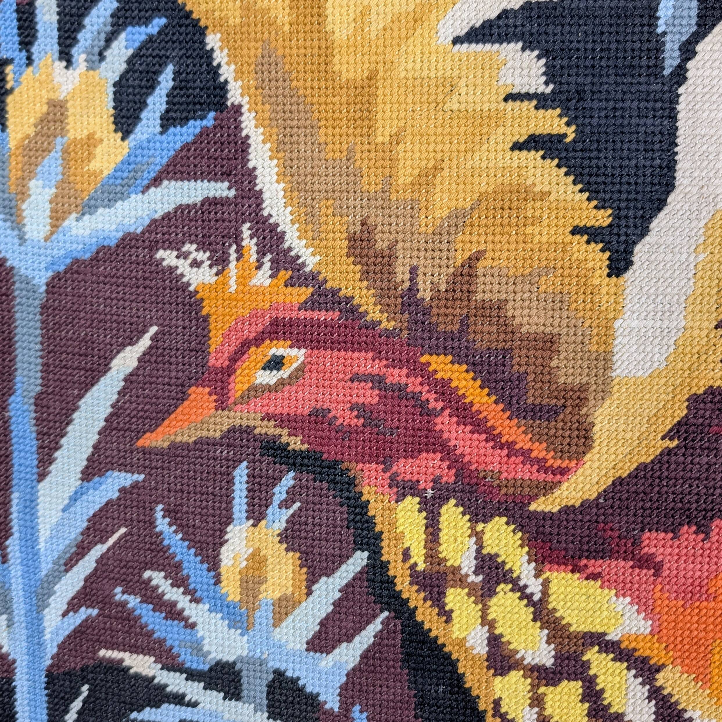 Framed embroidered canvas of a firebird.