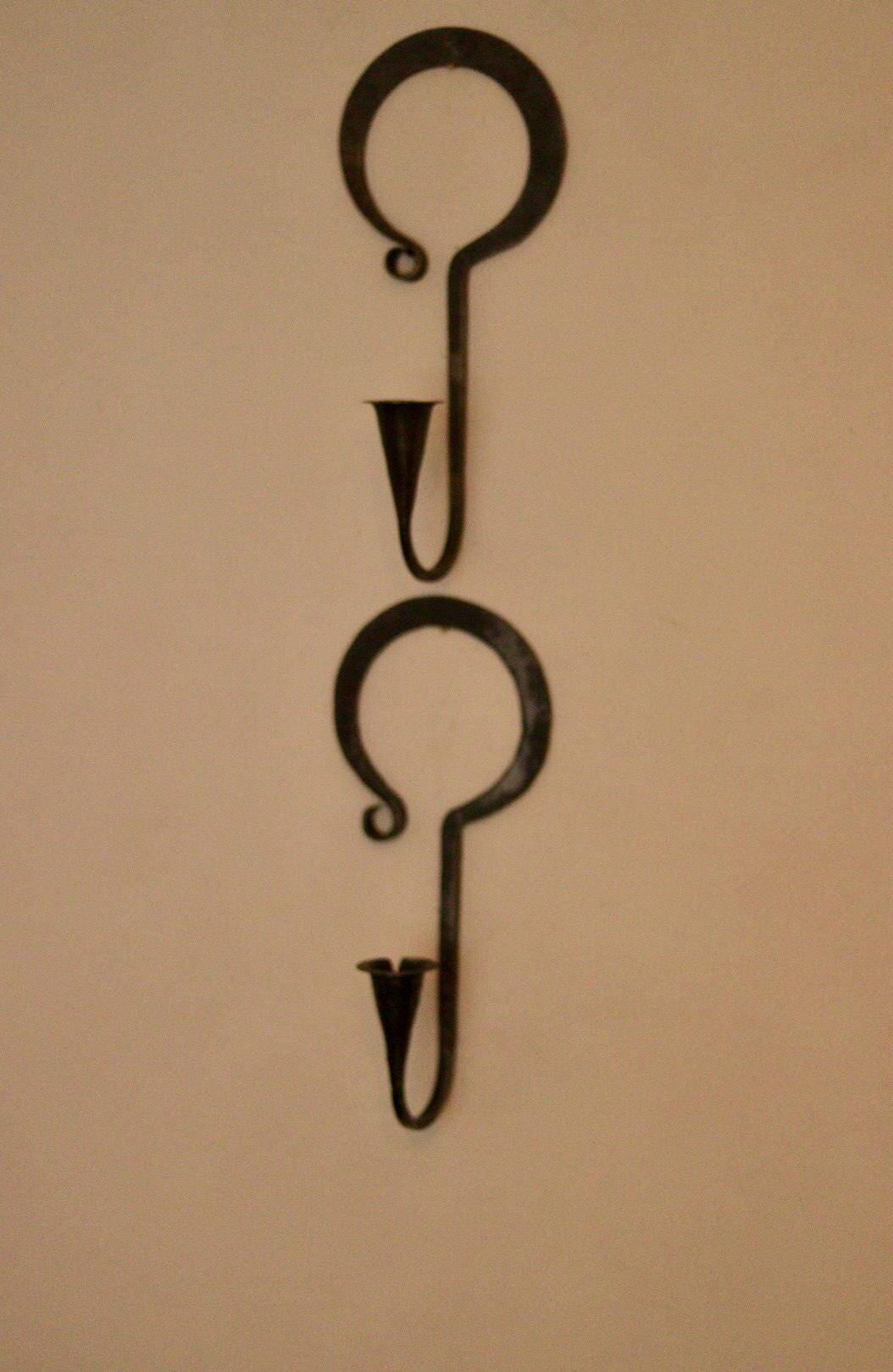 Pair of Swedish wall sconces in wrought iron, mid-20th century style, signed Akta.
