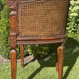Fauteuil en bois fruitier et cannage style Louis XVl
