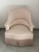 Pink armchair with patterns and fringes.