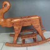 Decorative rocking elephant in carved exotic wood.