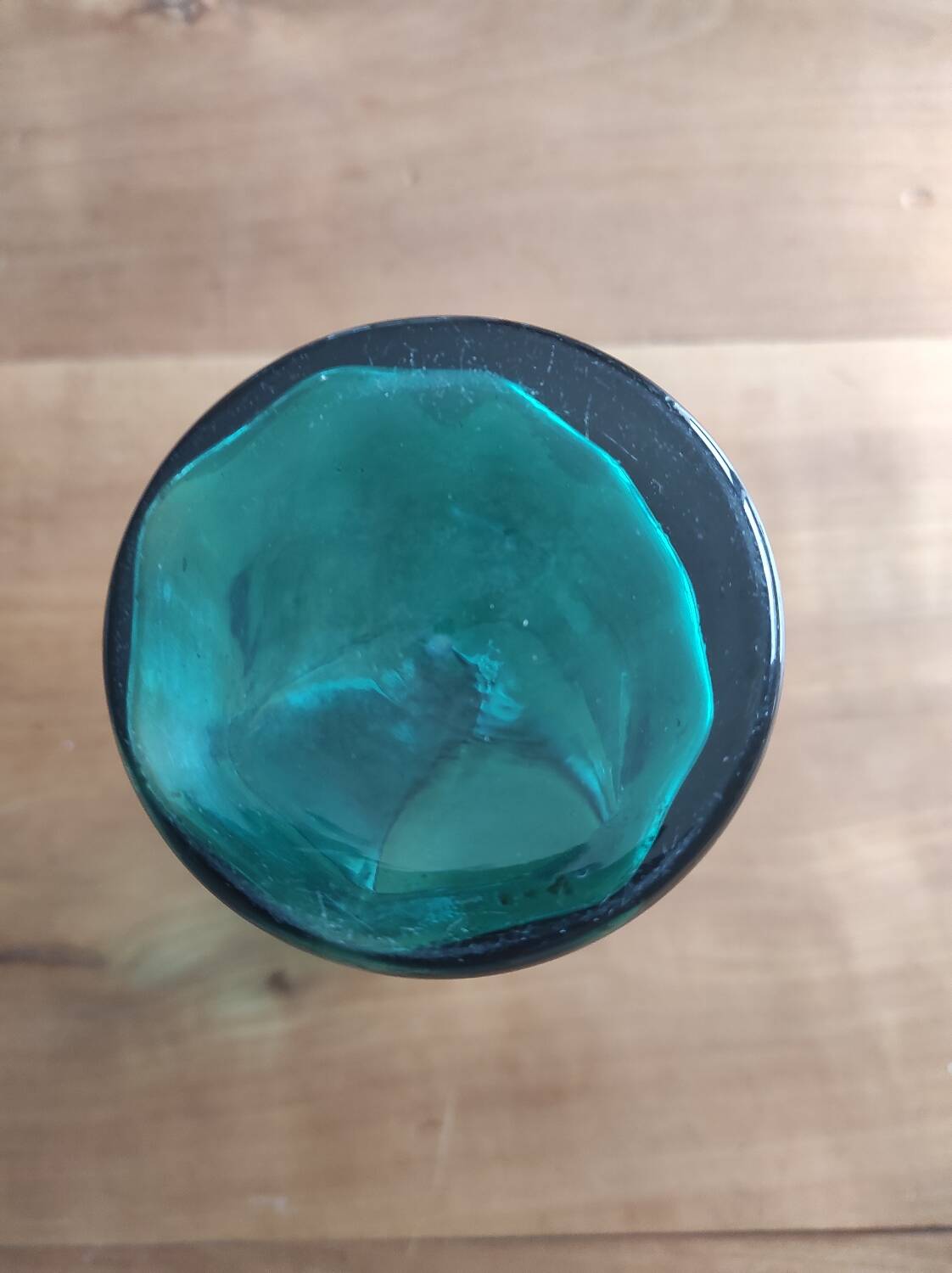 Blown glass vase with a flared neck and wavy rim.