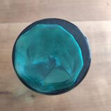 Blown glass vase with a flared neck and wavy rim.