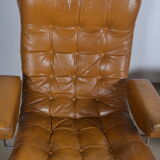 Fauteuil pivotant et son ottoman en cuir