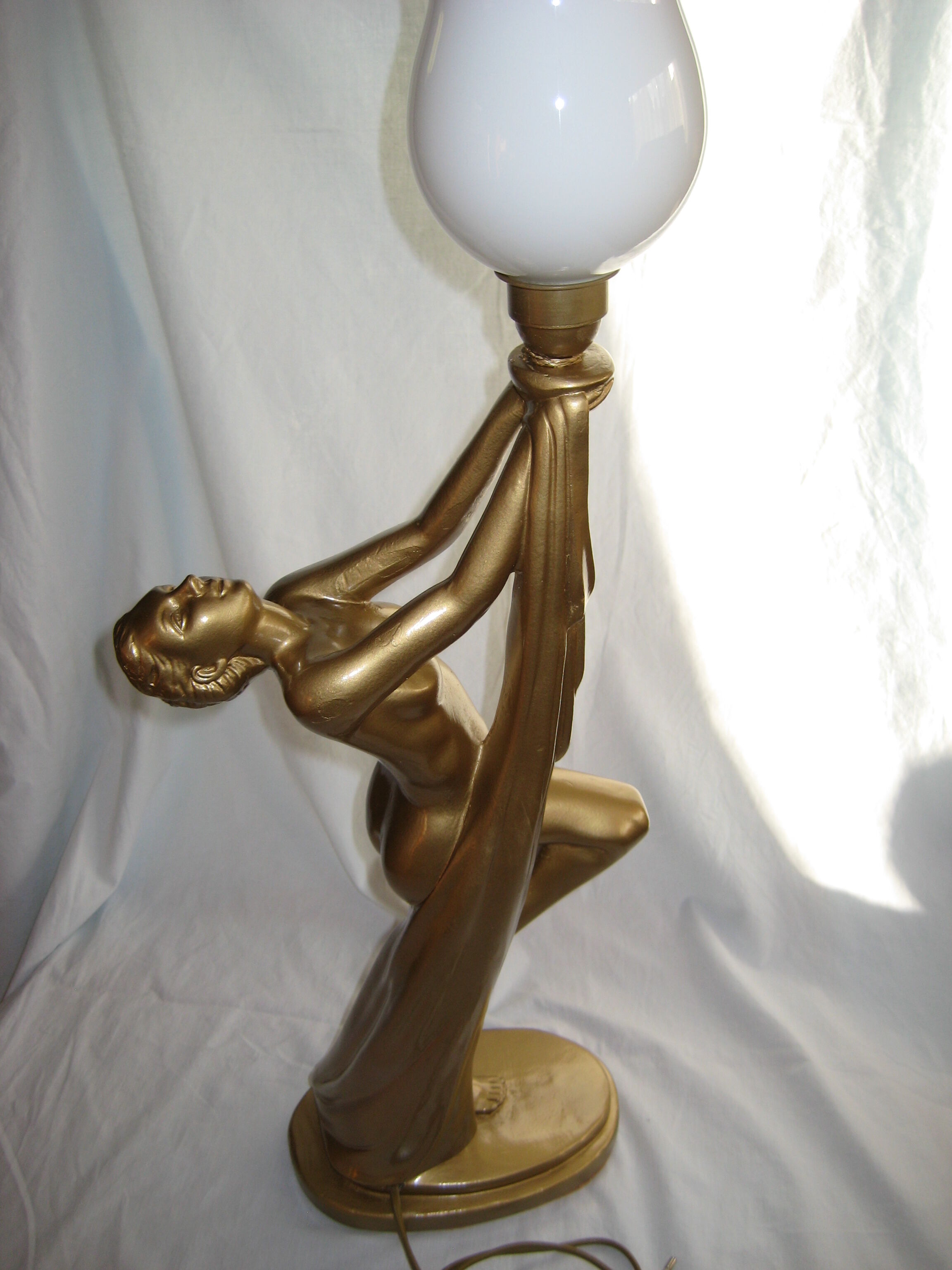 Lamp depicting a with a drape