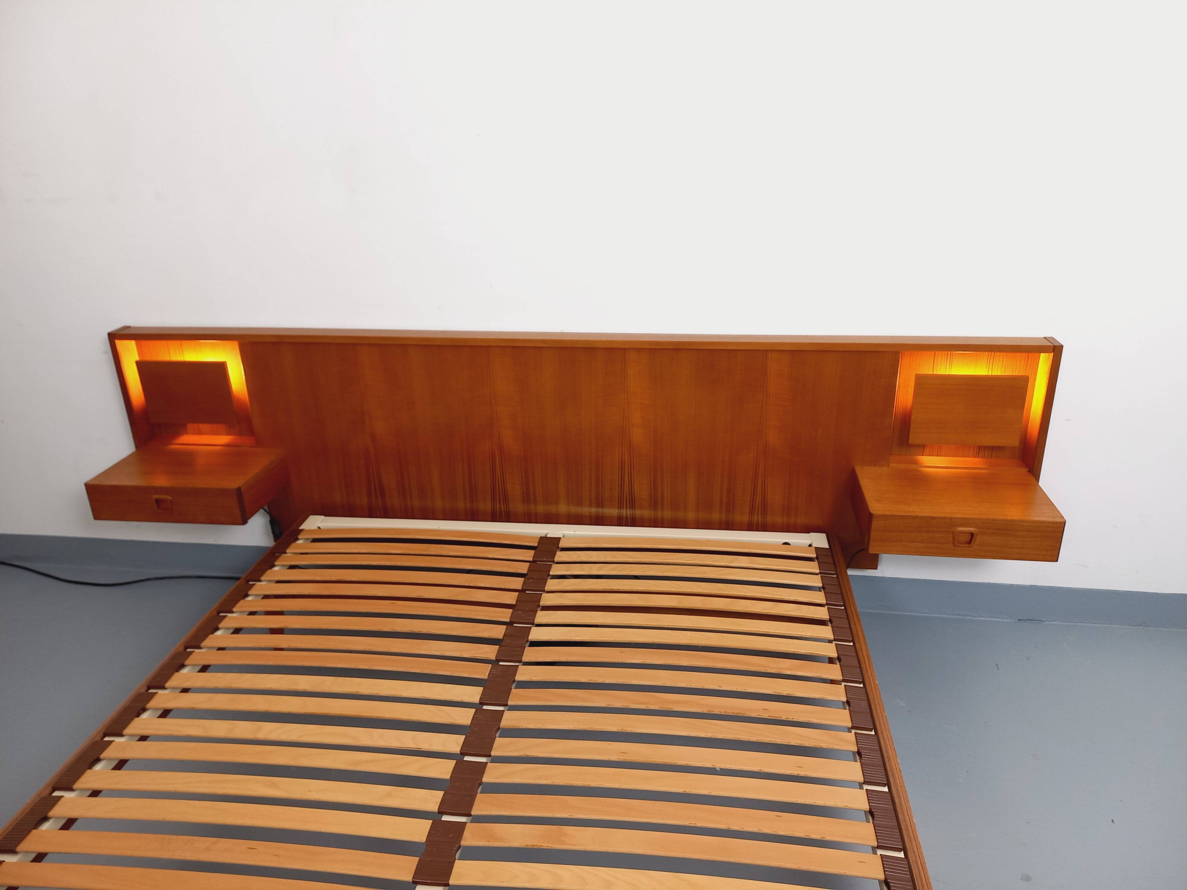 Double bed in vintage Scandinavian style from the 1960s with bedside tables in teak.