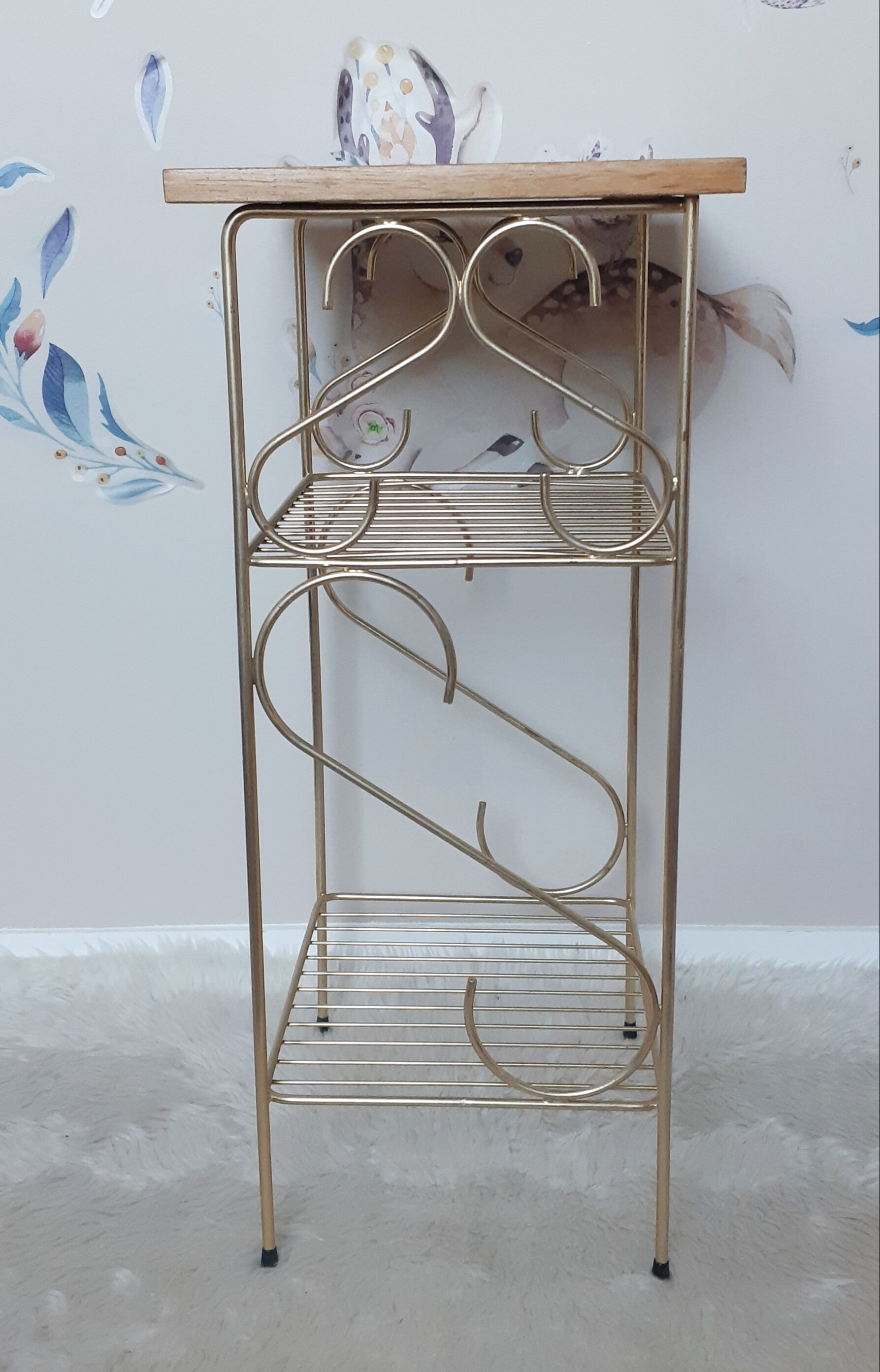 Side table with a golden magazine holder