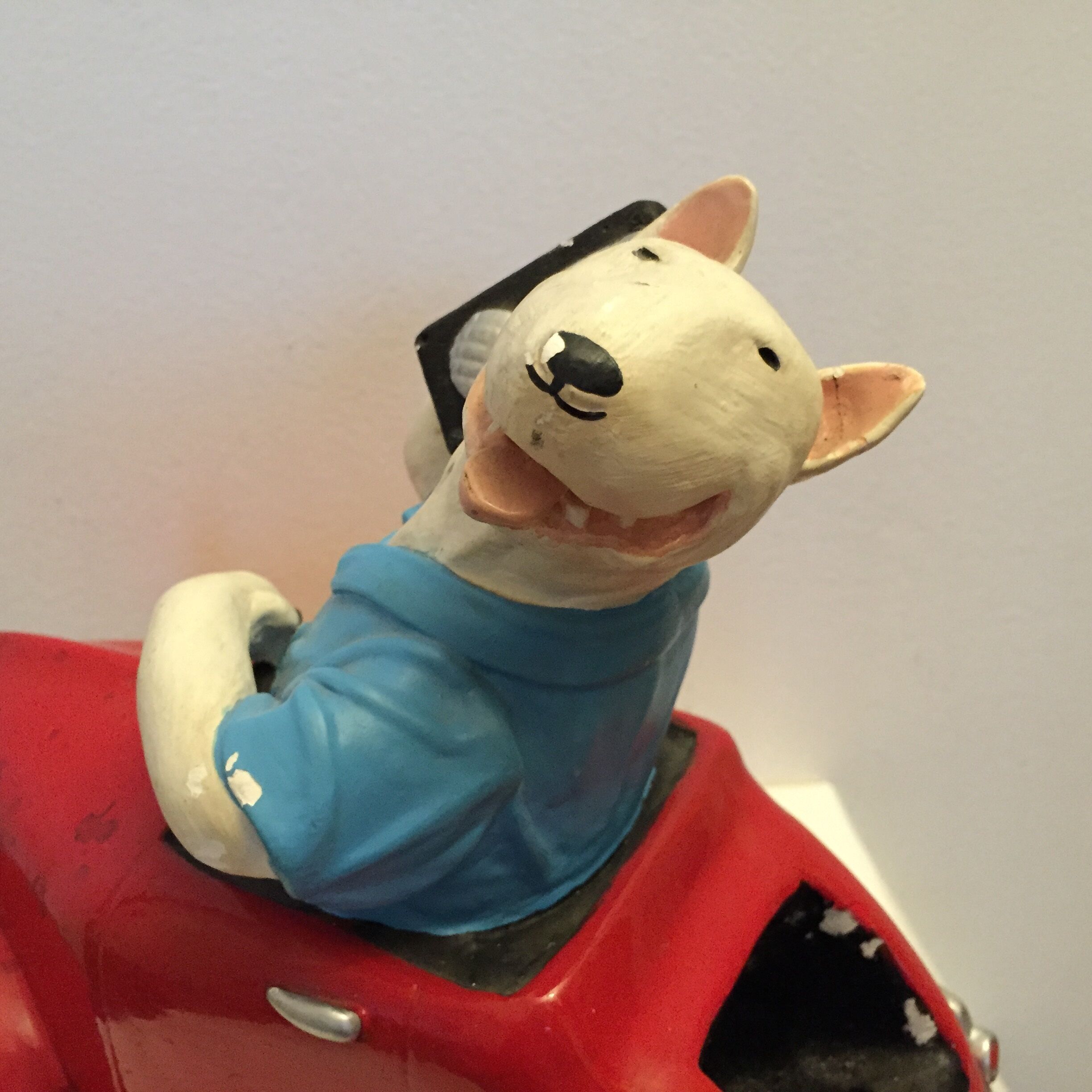 Dog toy driving his red car