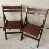 Pair of folding chairs in dark wooden slats