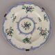 Antique earthenware plates with floral decoration from the 19th century.