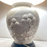 1980s ceramic table lamp with a wooden base and adjustable shade.