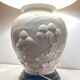 1980s ceramic table lamp with a wooden base and adjustable shade.
