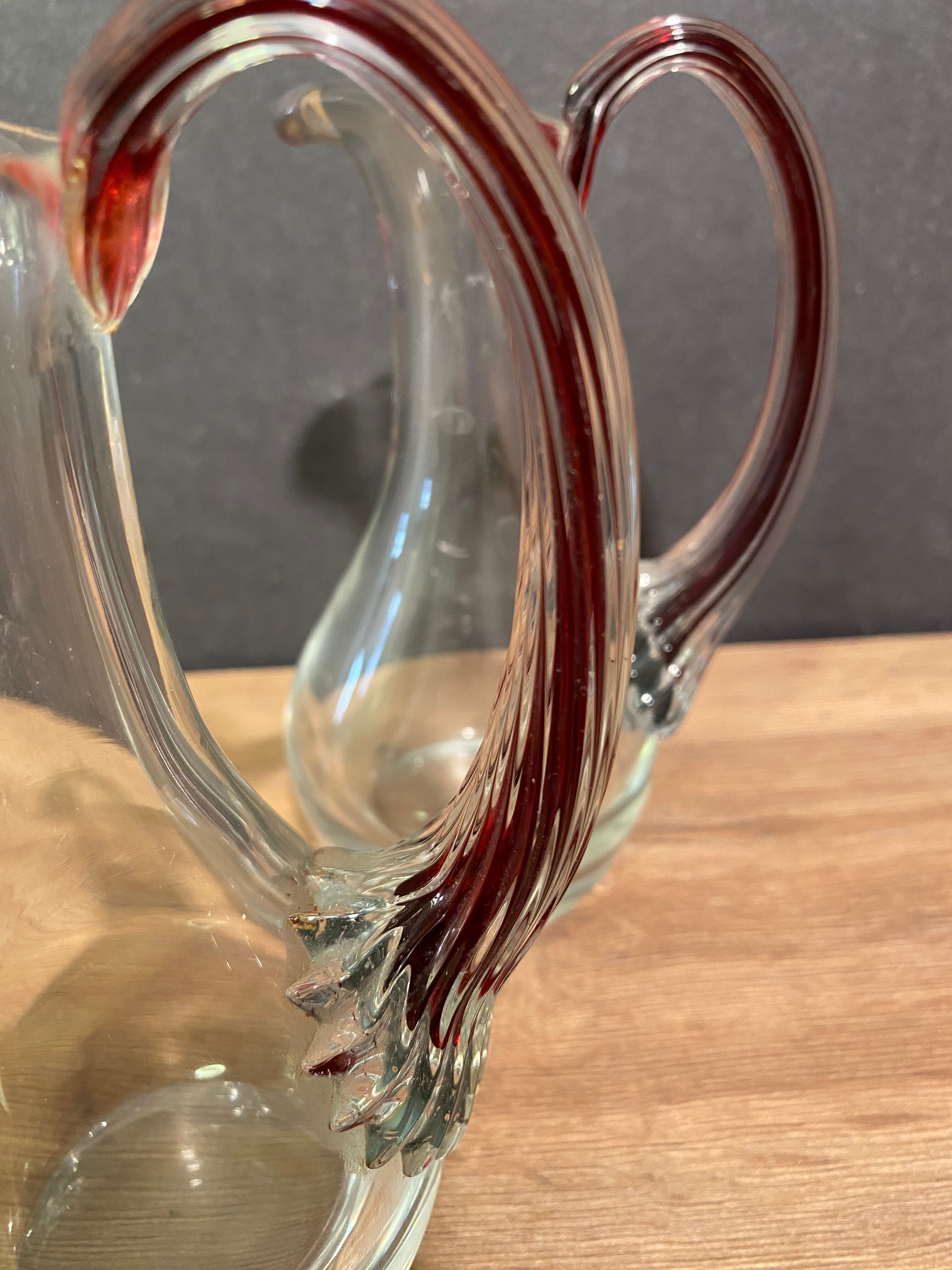 pair of crystal buires, handles with red tinted net decoration in the mass