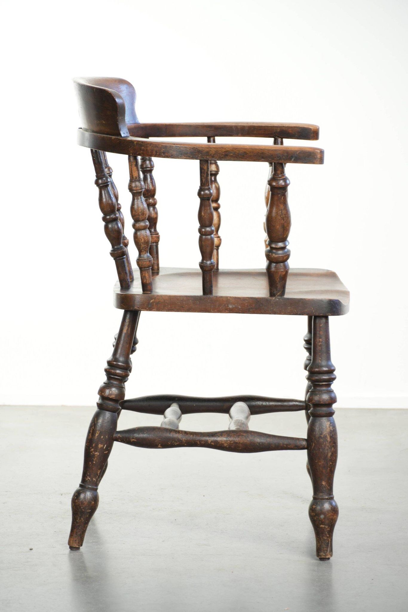 Wooden English antique pub/captain chair from the late 19th century