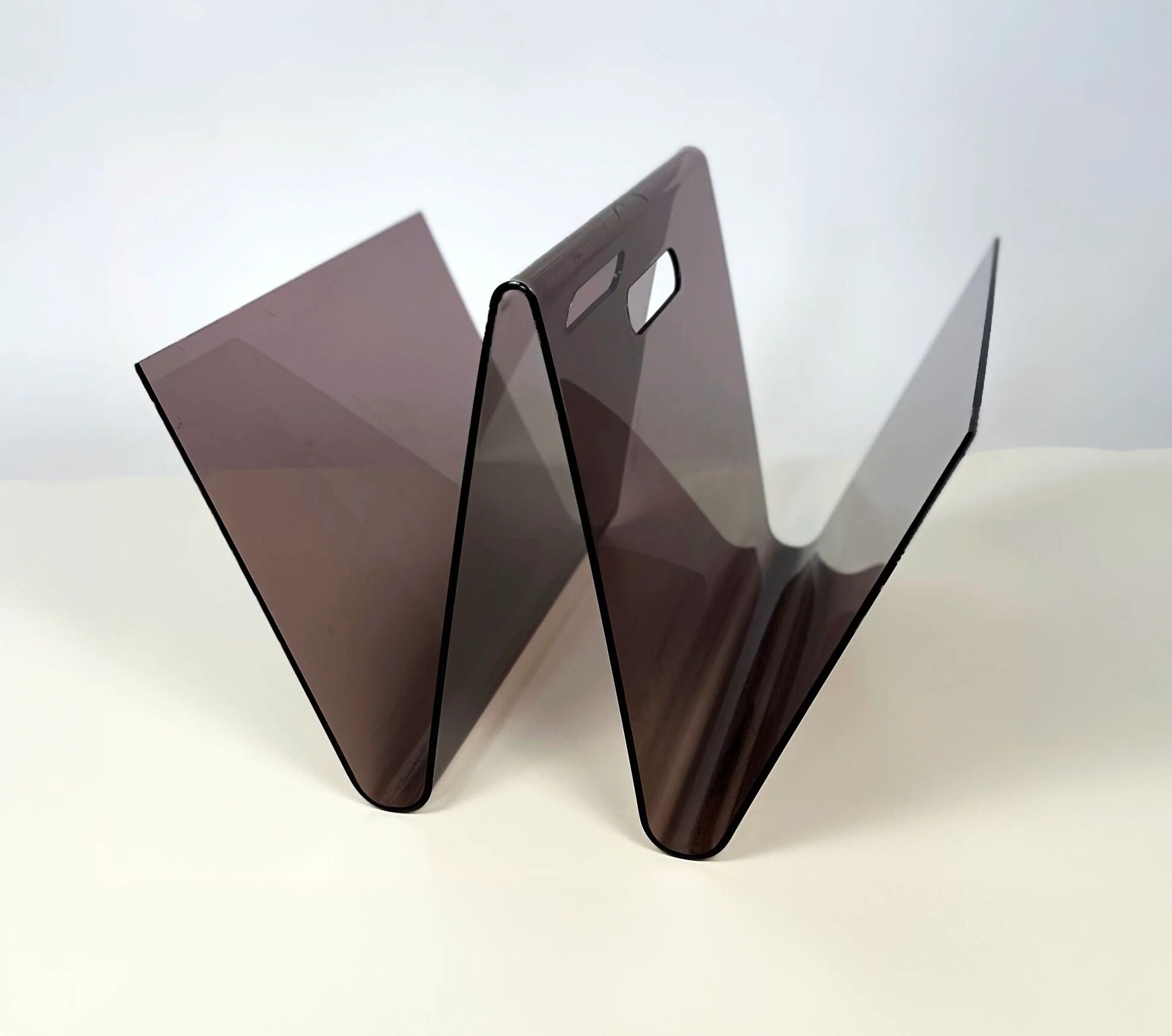 Smoked plexiglass magazine rack in the shape of a W — 1970s