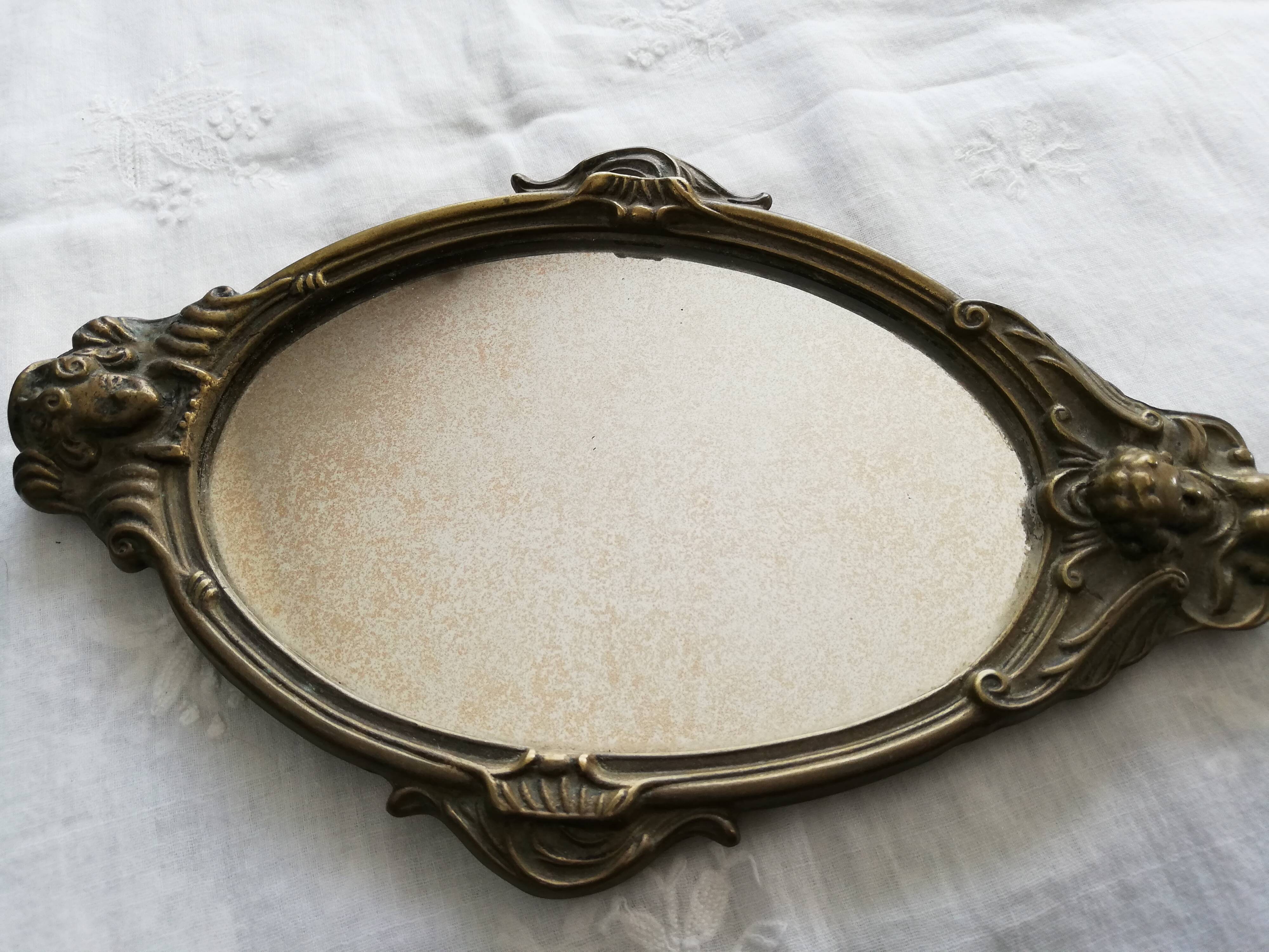 Old hand-facing mirror in gilded bronze