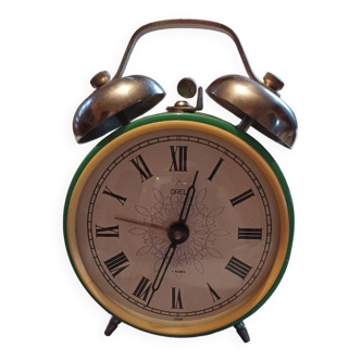Old green enameled alarm clock