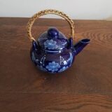 Small blue teapot and its wicker handle