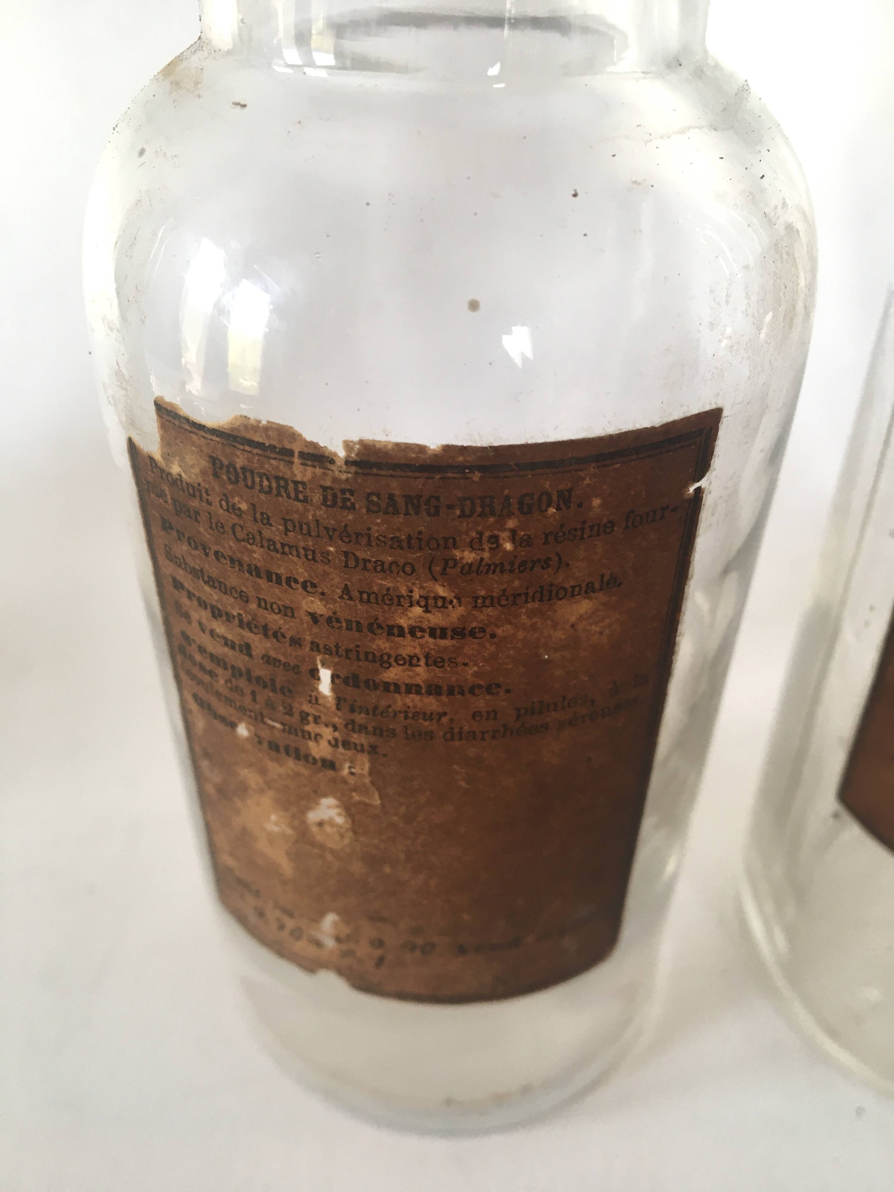 Trio apothecary bottles, painted metal caps